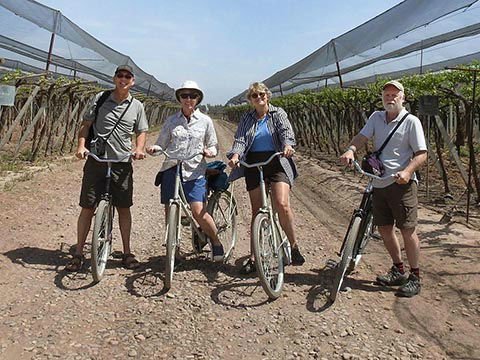 Sharon & Kelly cycling between vineyards in Mendoza